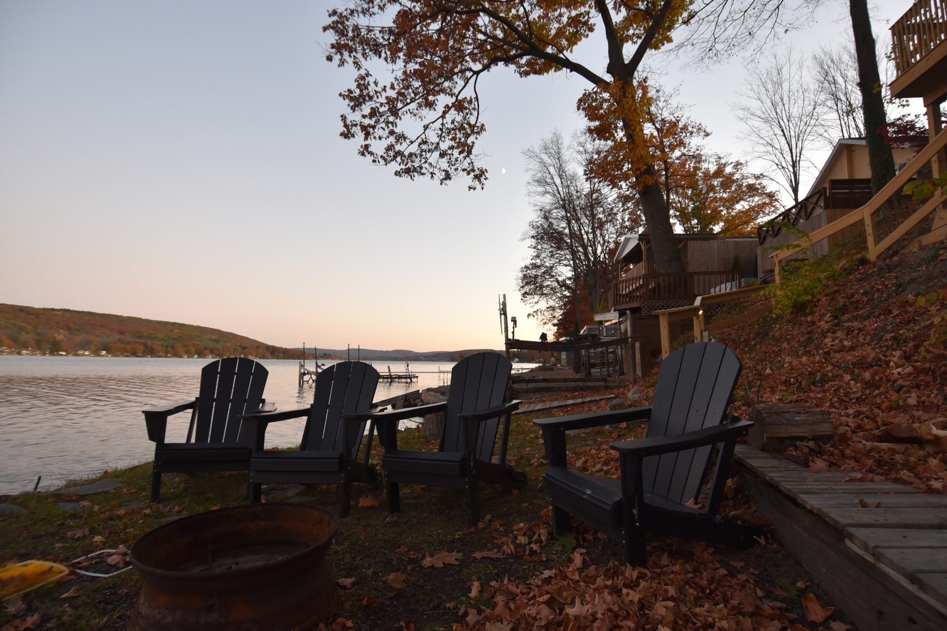 Adirondack chairs by the lake in fall